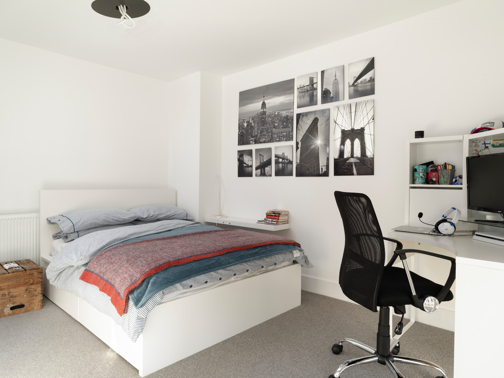 This is an example of a small contemporary teen’s room for boys in Sussex with white walls, carpet and grey floors.