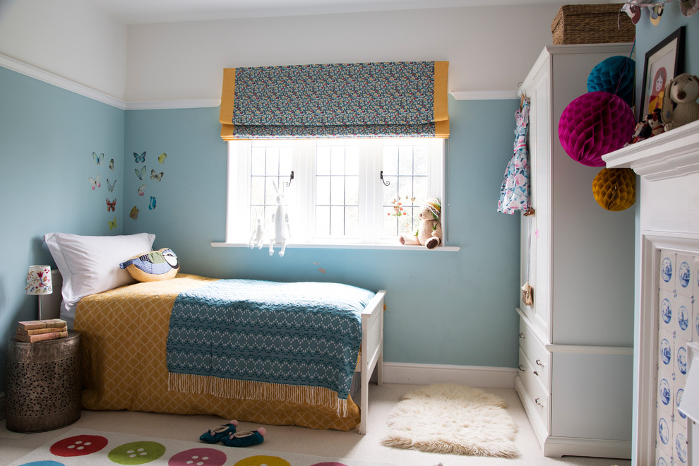 Medium sized classic children’s room for girls in Kent with blue walls.