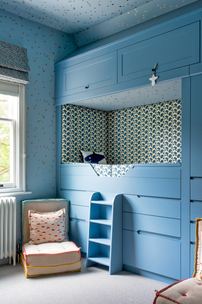 Photo of a classic gender neutral children’s room in London with blue walls, carpet and beige floors.