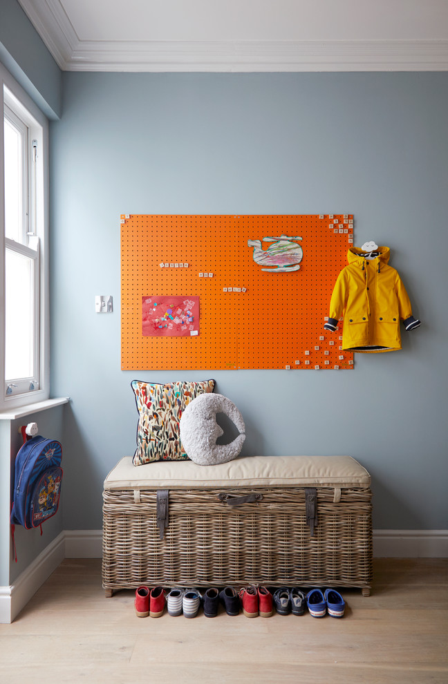 Large trendy light wood floor kids' room photo in London with blue walls