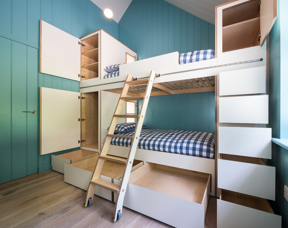 Photo of a large scandi gender neutral children’s room in Other with light hardwood flooring and beige floors.