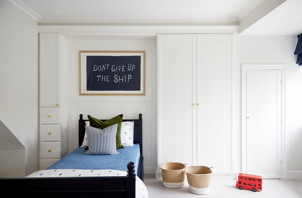 Inspiration for a classic children’s room for boys in London with white walls, carpet and grey floors.