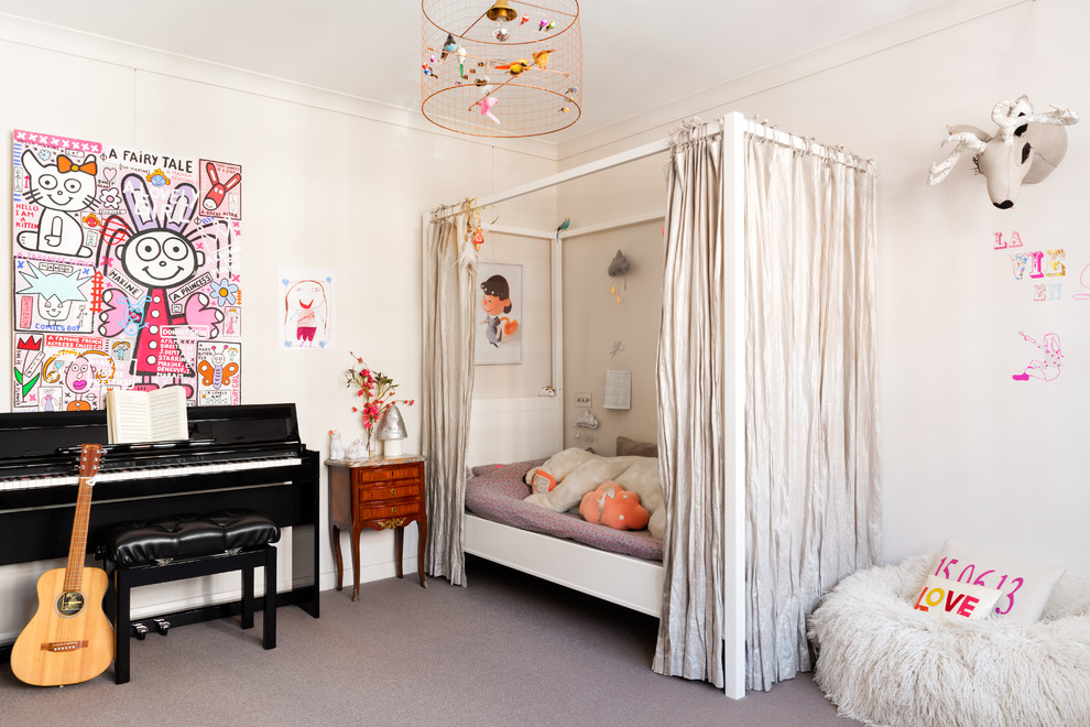 Photo of a contemporary kids' bedroom for girls in London with white walls and carpet.