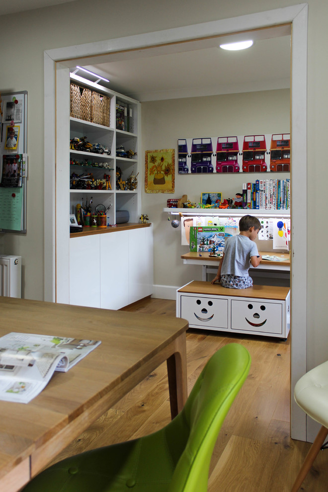 Photo of a contemporary kids' bedroom in Cambridgeshire with medium hardwood flooring.