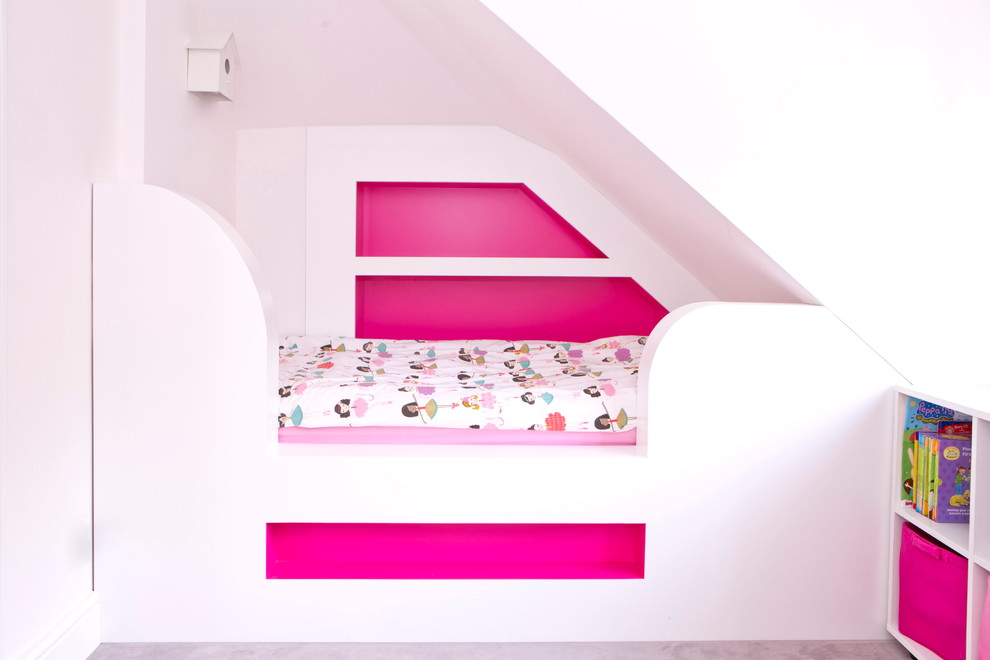 This is an example of a contemporary toddler’s room for girls in London with multi-coloured walls.
