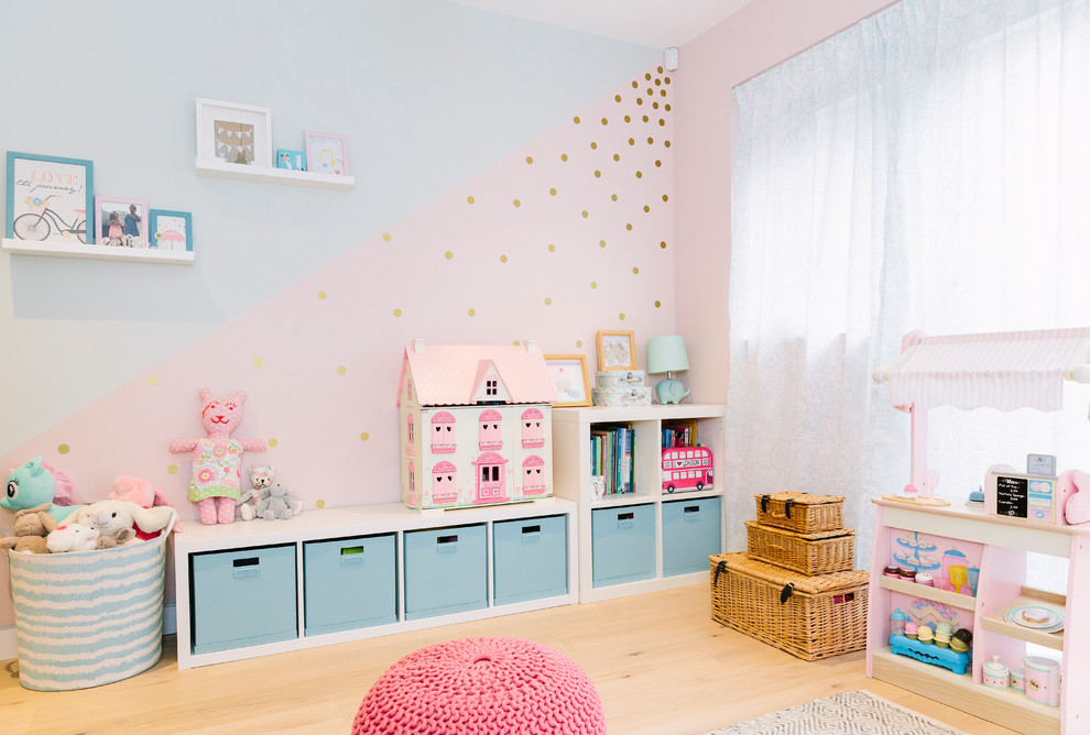 Example of a trendy girl beige floor childrens' room design in London with blue walls