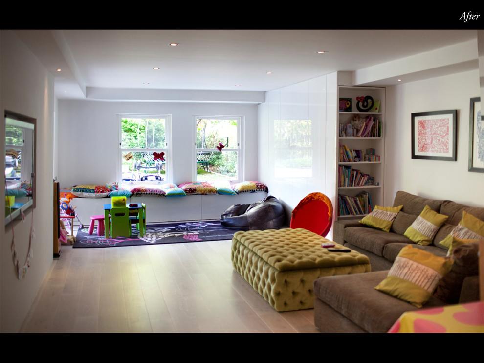 Inspiration for a mid-sized contemporary gender-neutral playroom remodel in London with white walls