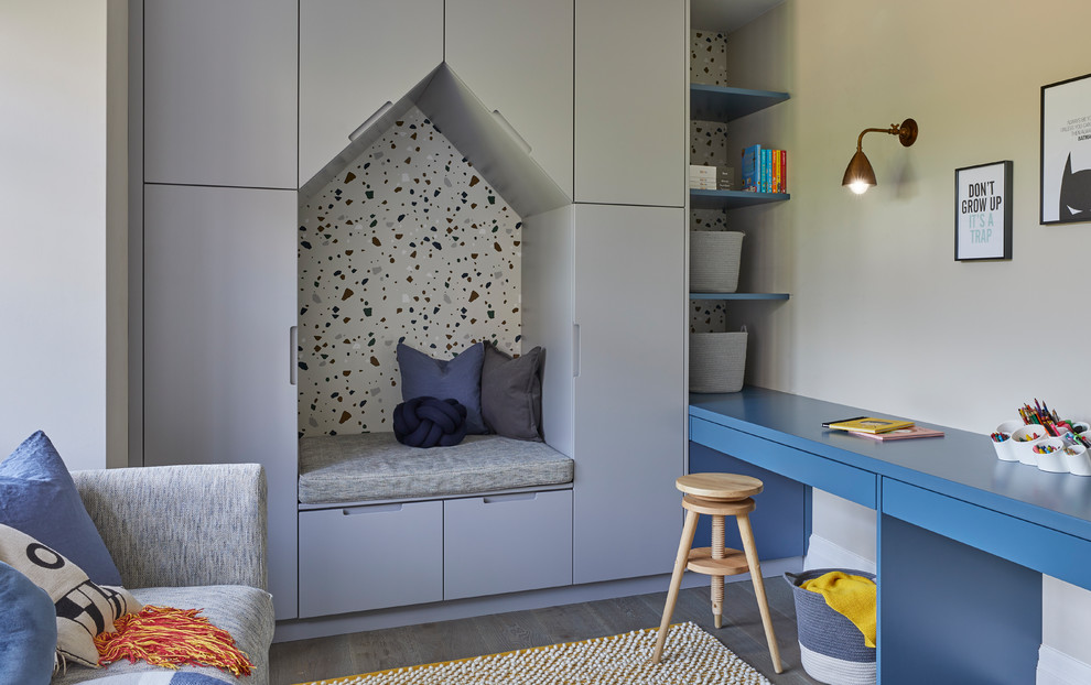 This is an example of a contemporary children’s room for boys in Hertfordshire with grey walls and dark hardwood flooring.