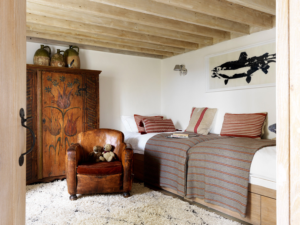 Kids' room - mid-sized rustic gender-neutral kids' room idea in London with white walls