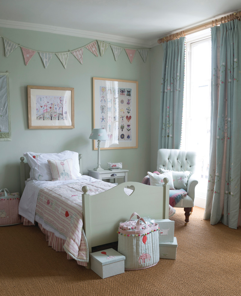 Inspiration for a medium sized farmhouse gender neutral children’s room in Wiltshire with carpet and green walls.