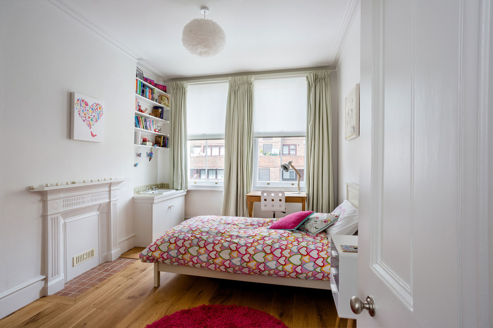 Design ideas for a classic kids' bedroom in London with white walls, medium hardwood flooring and brown floors.