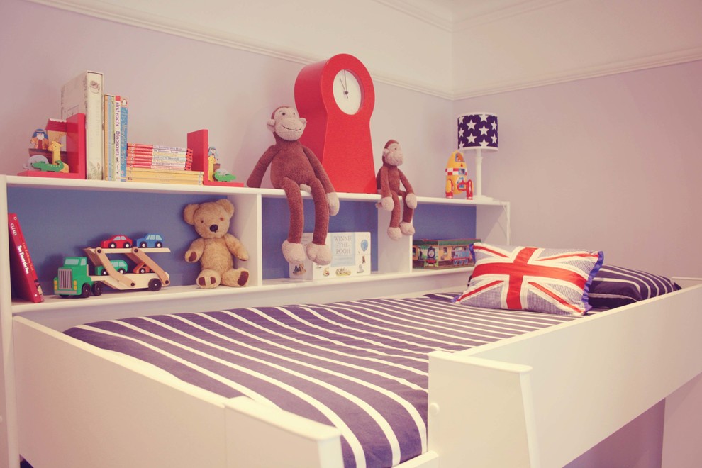 Inspiration for a medium sized classic toddler’s room for boys in London with carpet.