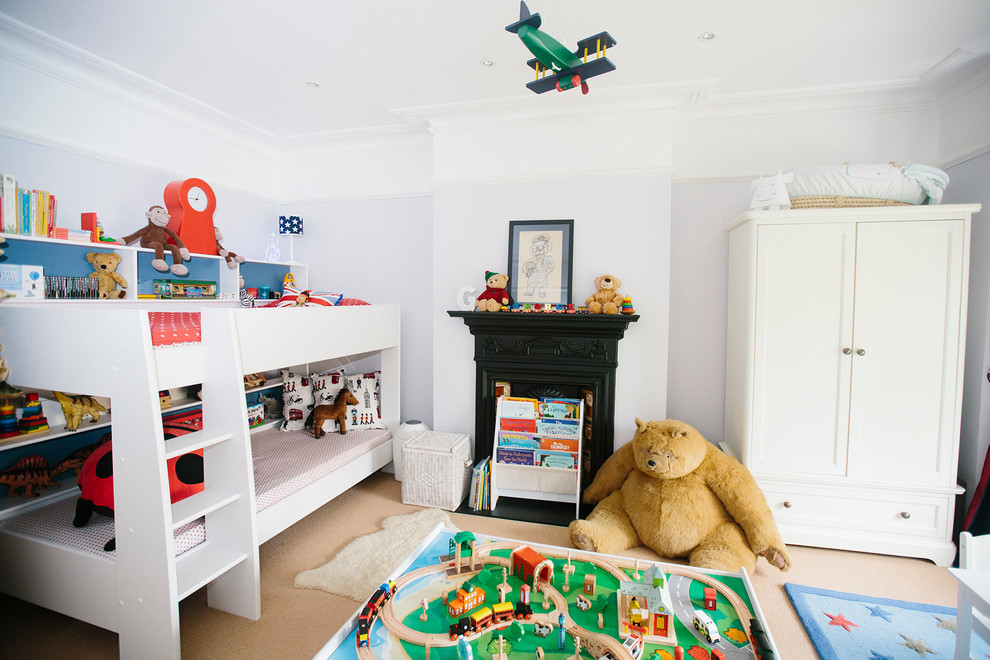 Inspiration for a medium sized traditional toddler’s room for boys in London with carpet.