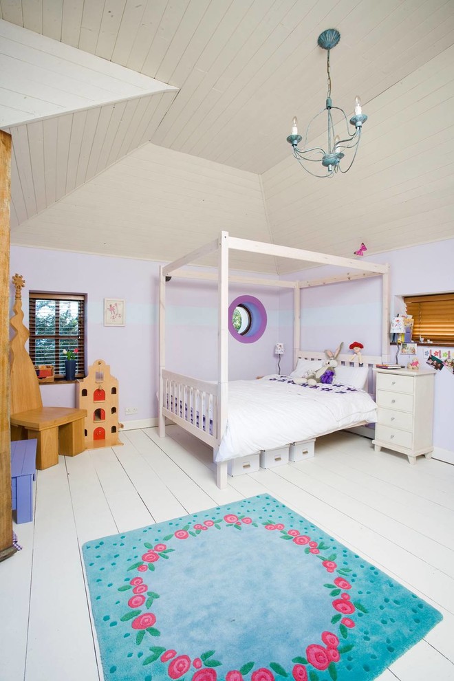 This is an example of a traditional children’s room for girls in Dublin with purple walls.