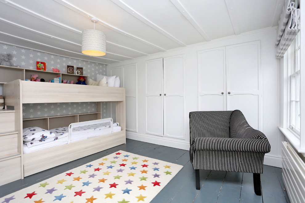 Design ideas for a medium sized scandinavian gender neutral children’s room in London with white walls, painted wood flooring and grey floors.