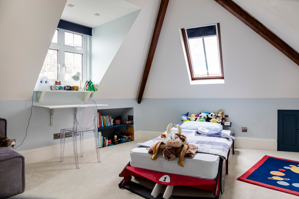 Photo of a large contemporary children’s room for boys in London with blue walls, carpet and beige floors.