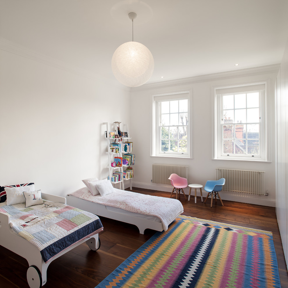 Design ideas for a medium sized contemporary gender neutral toddler’s room in London with white walls, dark hardwood flooring and brown floors.