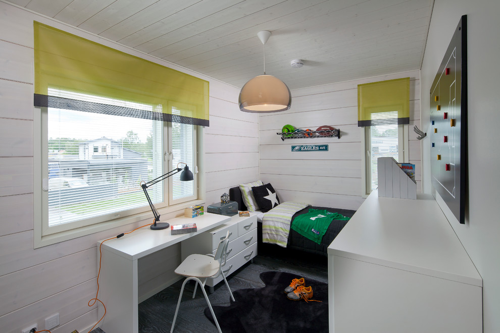 Example of a danish boy dark wood floor kids' room design in Devon with white walls