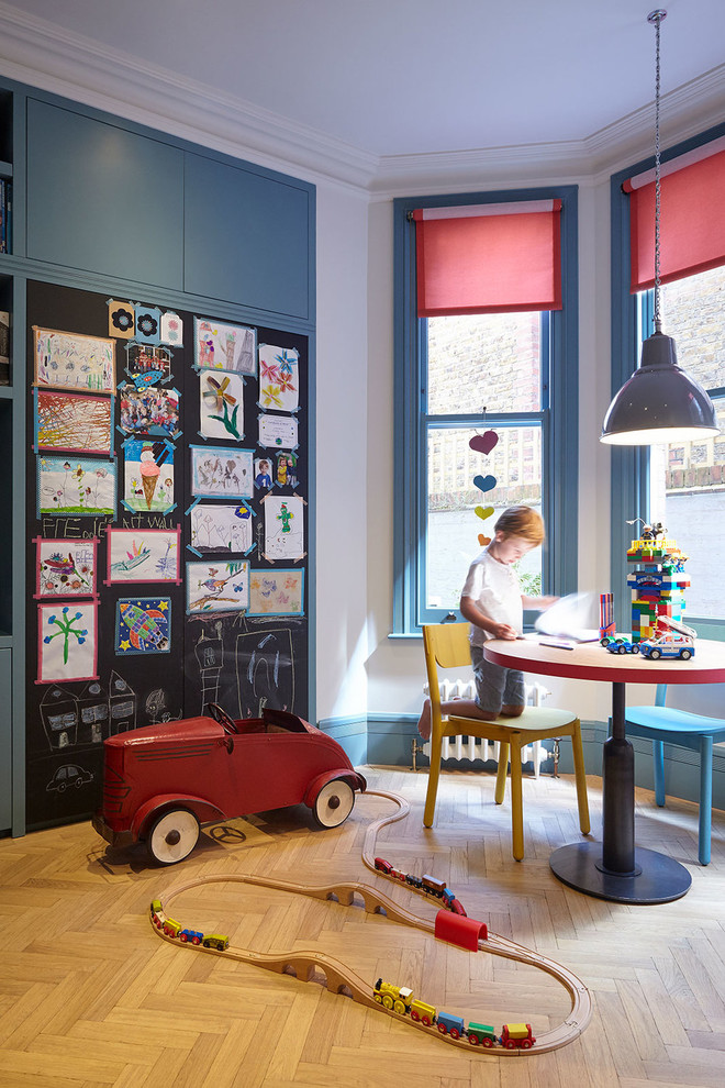 Medium sized classic kids' bedroom for boys in London with light hardwood flooring and beige floors.