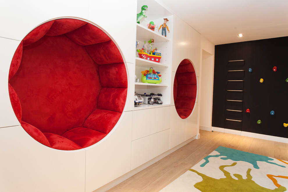 Contemporary gender neutral kids' bedroom in London with white walls and light hardwood flooring.