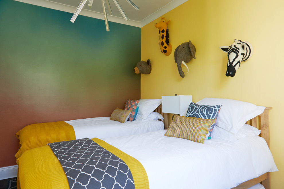 Eclectic gender neutral children’s room in London with yellow walls.