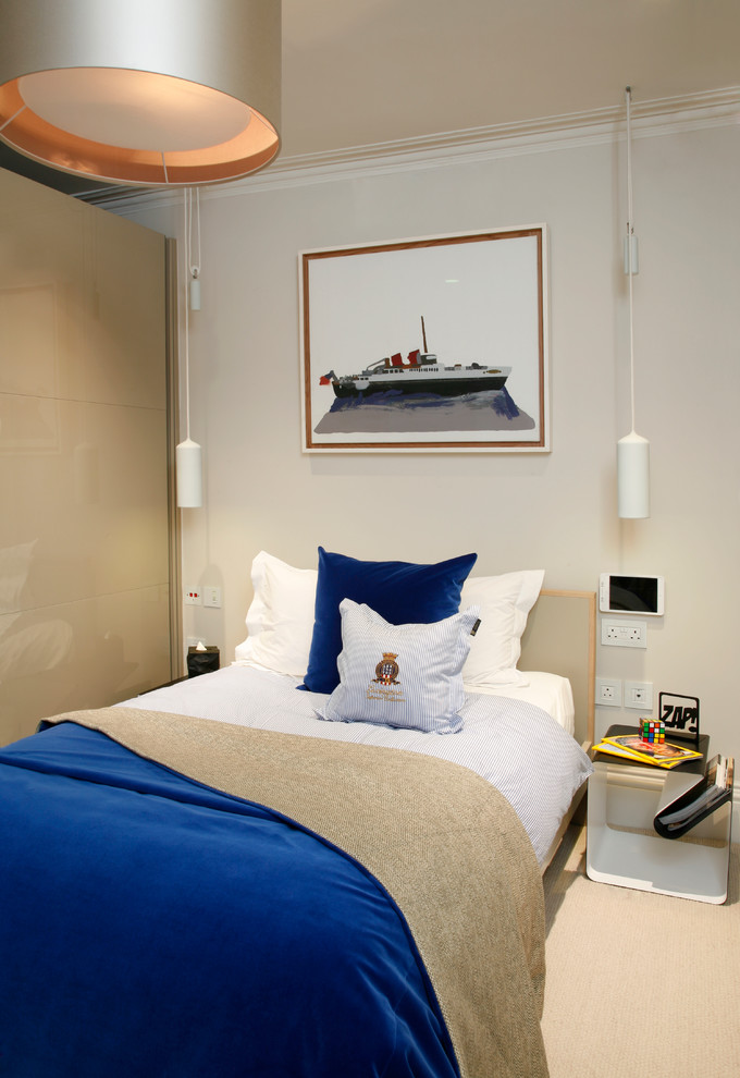 Medium sized contemporary teen’s room for boys in London with beige walls.