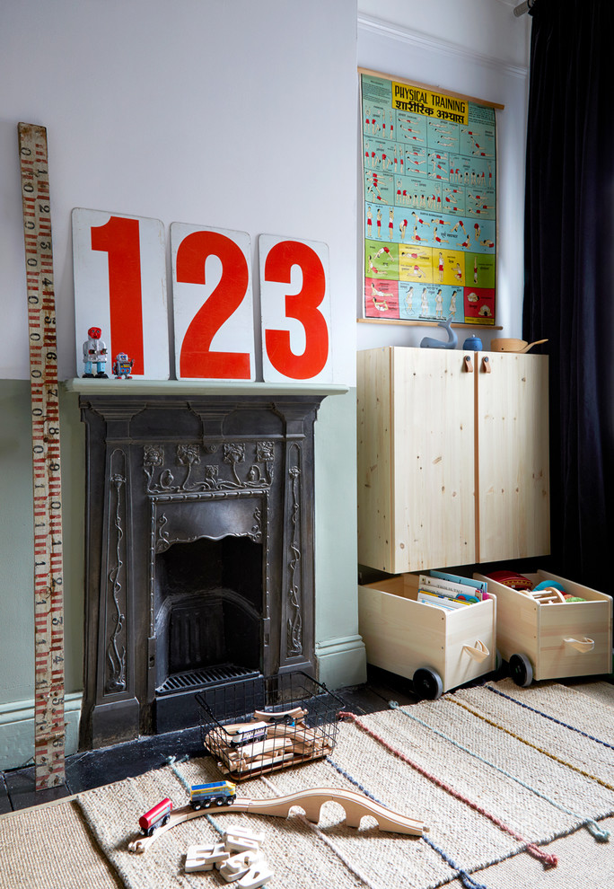 Scandinavian kids' bedroom for boys in London with multi-coloured walls and a chimney breast.