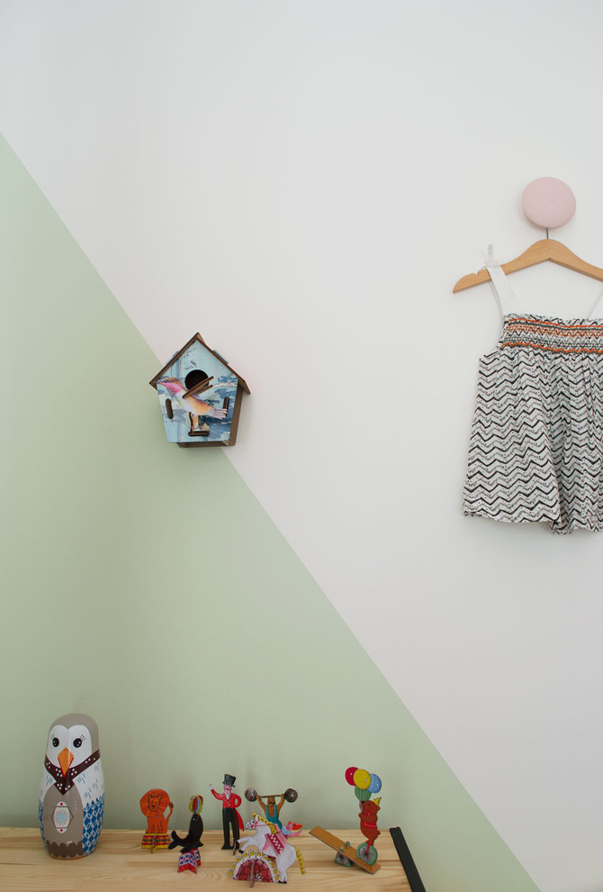Foto på ett litet minimalistiskt könsneutralt barnrum kombinerat med sovrum och för 4-10-åringar, med vita väggar och heltäckningsmatta