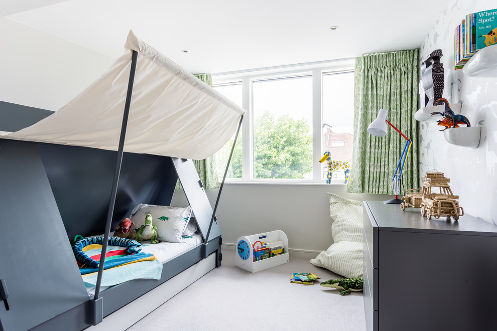 This is an example of a traditional kids' bedroom for boys in London with beige walls, carpet and beige floors.