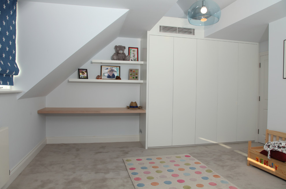 Modern inredning av ett stort pojkrum kombinerat med sovrum och för 4-10-åringar, med vita väggar och heltäckningsmatta