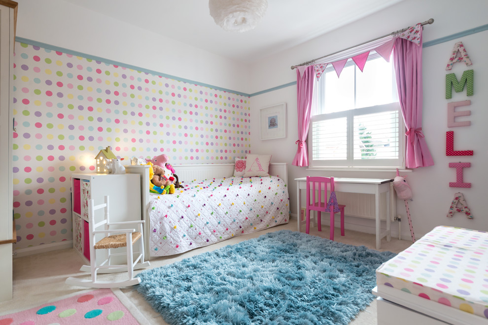 Photo of a small traditional children’s room for girls in Surrey with carpet, beige floors and multi-coloured walls.