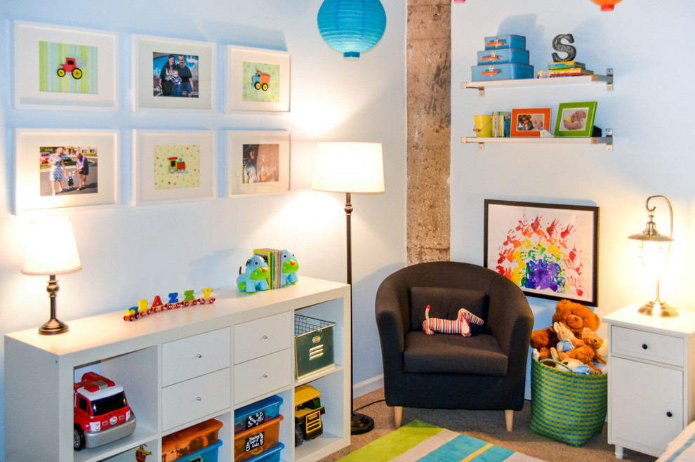 Medium sized traditional toddler’s room for boys in Chicago with blue walls and carpet.