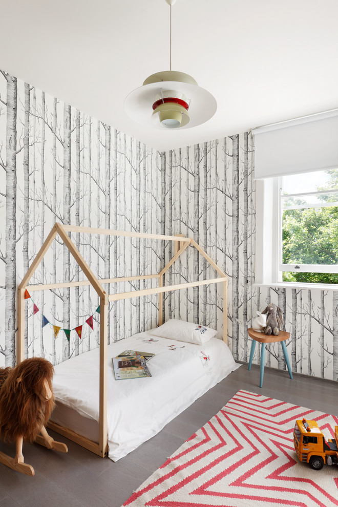 This is an example of a medium sized scandi gender neutral children’s room in London with grey floors and grey walls.
