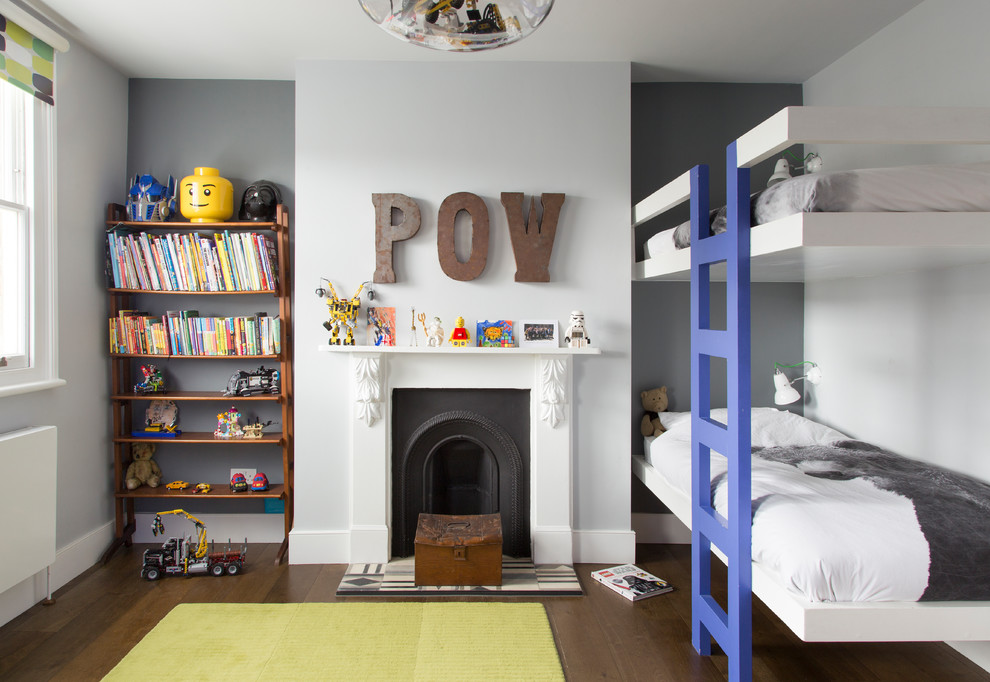 Medium sized contemporary children’s room for boys in London with grey walls, dark hardwood flooring, brown floors and a chimney breast.
