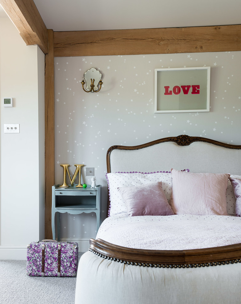 This is an example of a country teen’s room for girls in West Midlands with white walls, carpet and grey floors.