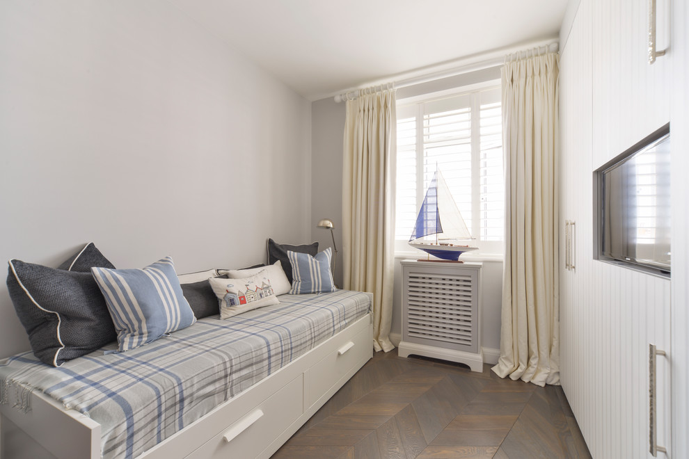 Design ideas for a small nautical children’s room for boys in London with grey walls, dark hardwood flooring and brown floors.