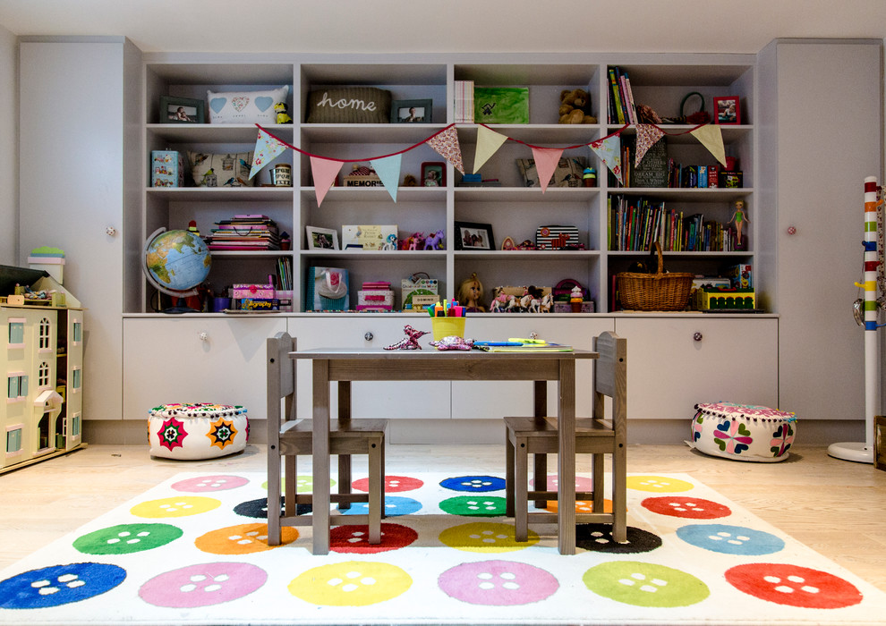 Photo of a traditional gender neutral kids' bedroom in Other with light hardwood flooring.