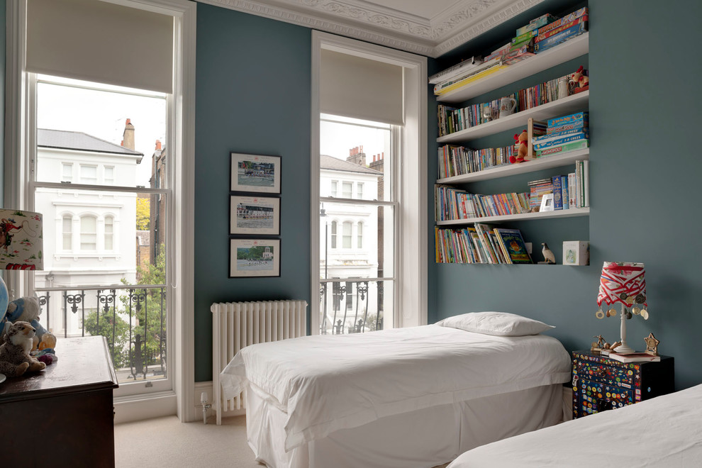 Inspiration for a mid-sized eclectic boy carpeted and beige floor kids' room remodel in London with blue walls