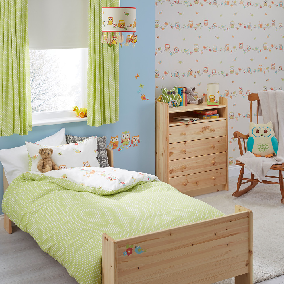 Small trendy gender-neutral light wood floor kids' room photo in Hampshire with blue walls