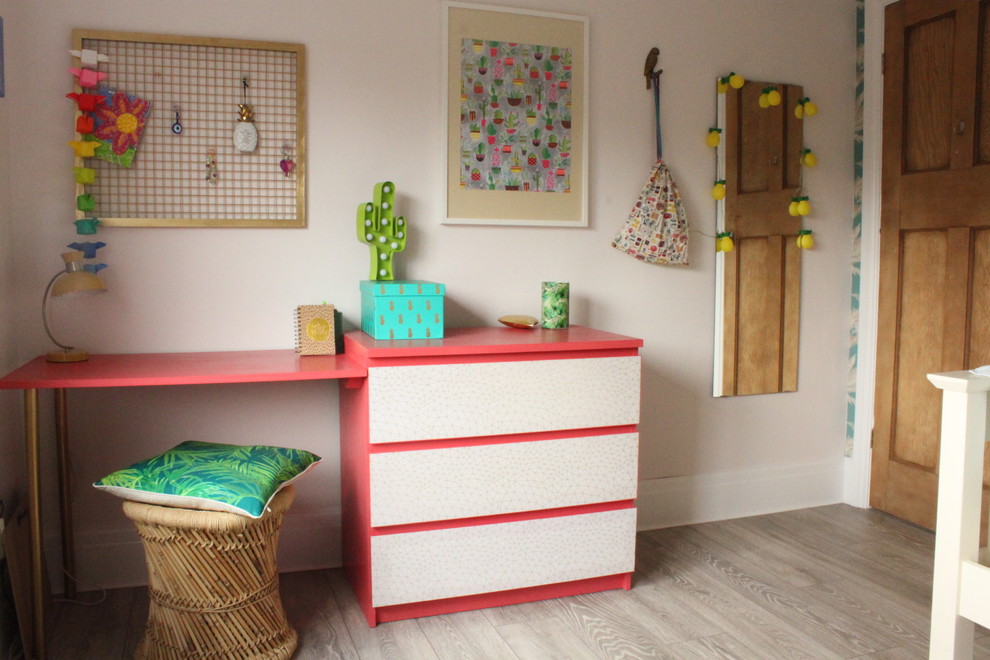 Photo of a medium sized contemporary teen’s room for girls in West Midlands with multi-coloured walls and laminate floors.