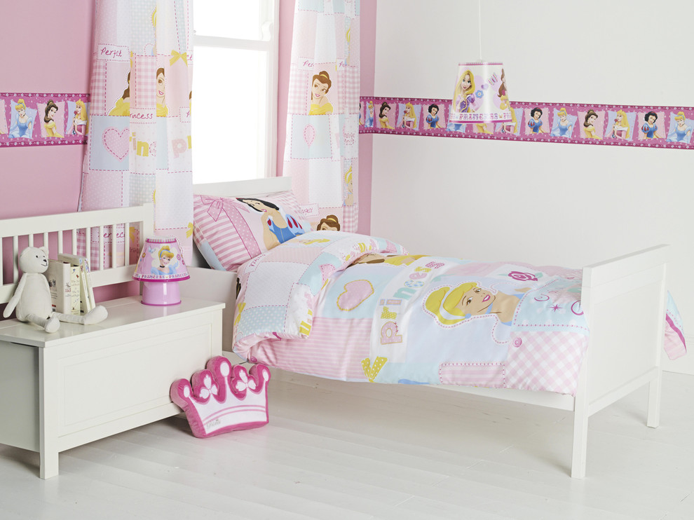 Small contemporary children’s room for girls in Hampshire with light hardwood flooring and multi-coloured walls.