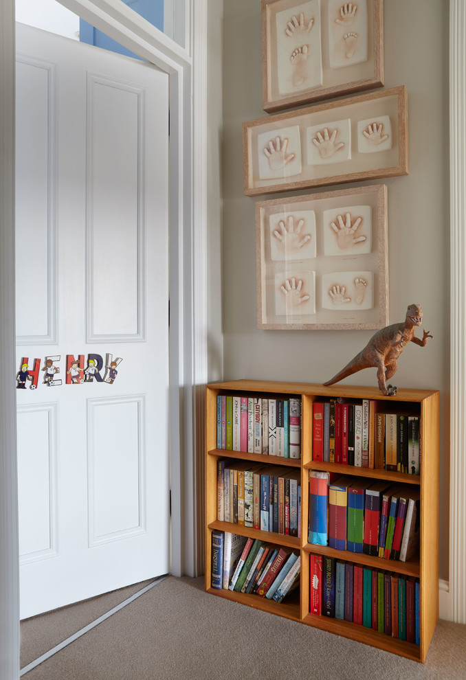 Photo of a contemporary kids' bedroom for boys in London with beige walls and carpet.