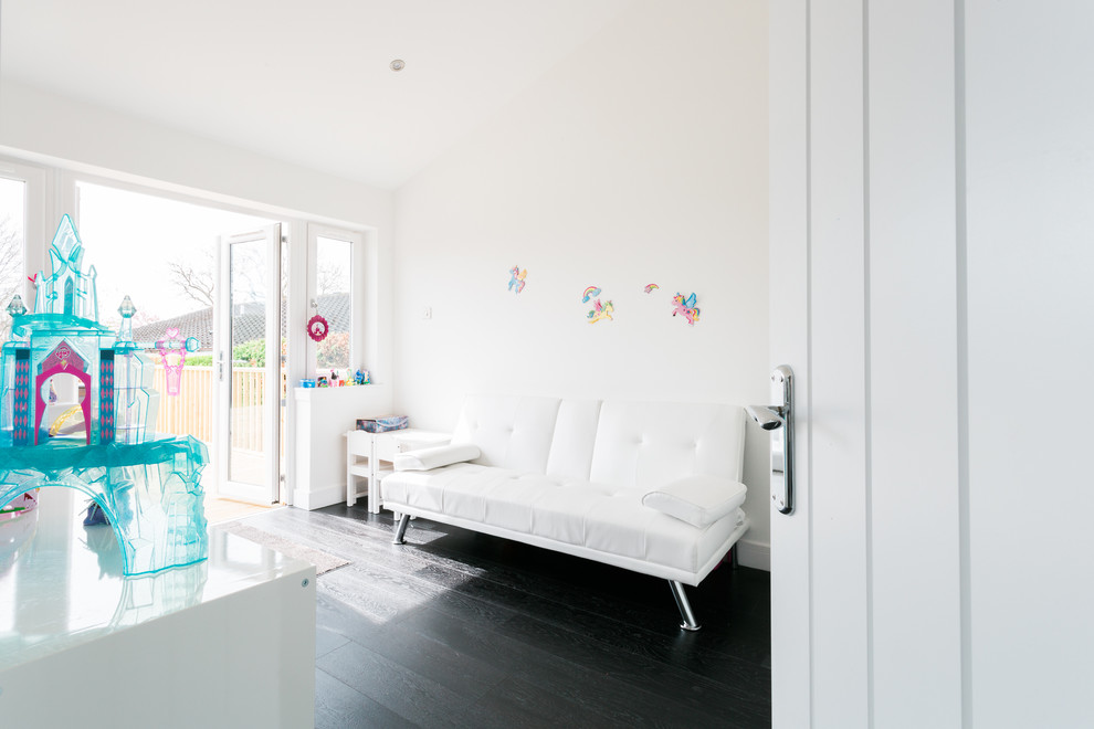 Medium sized contemporary kids' bedroom for girls in Glasgow with white walls, dark hardwood flooring and black floors.