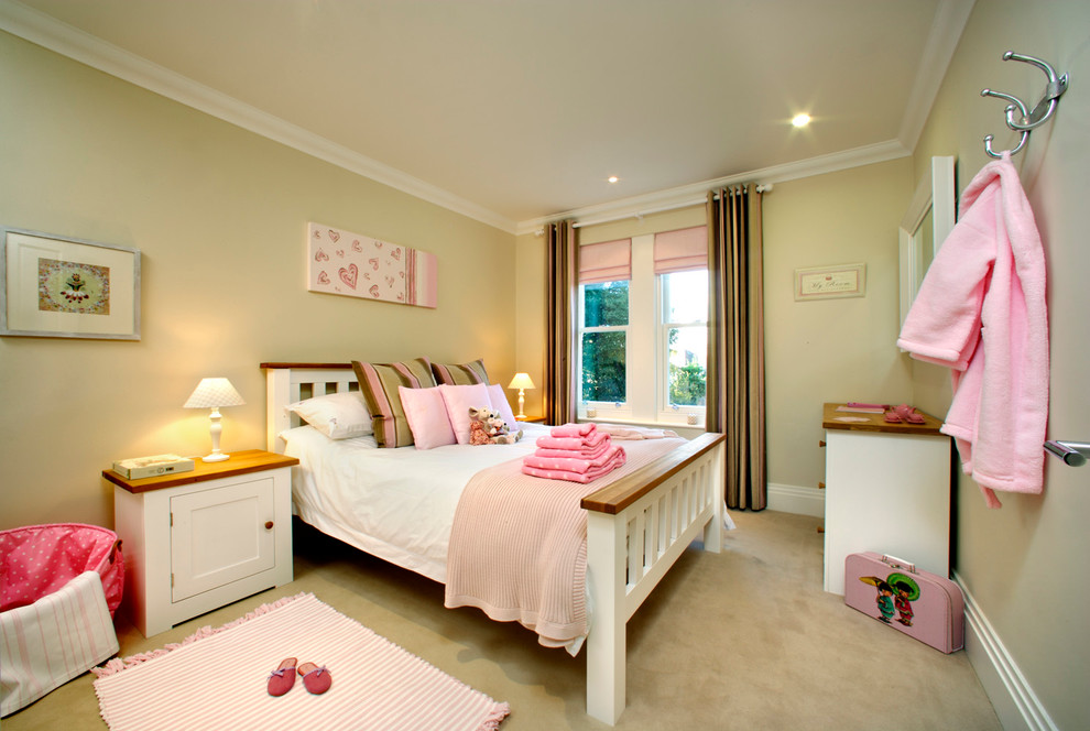 Elegant girl carpeted kids' room photo in London with yellow walls