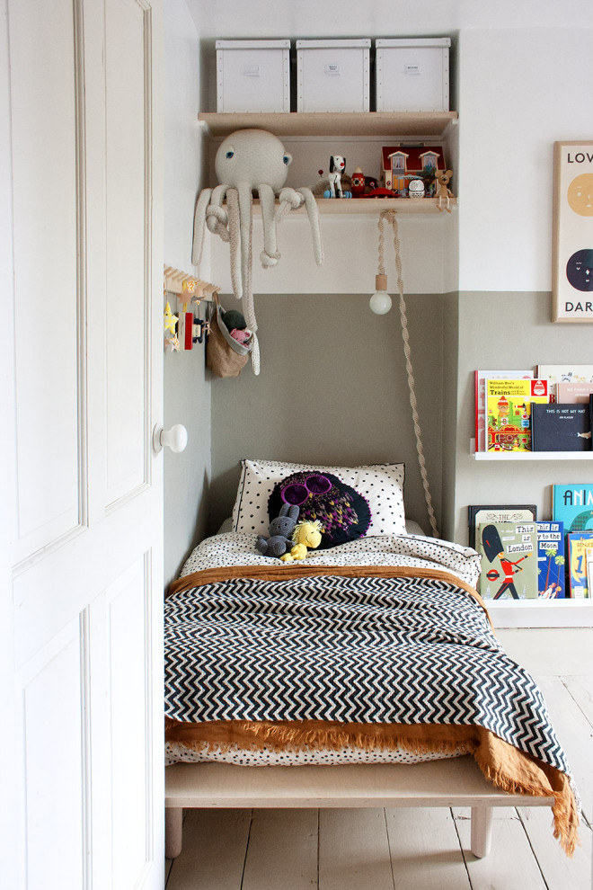 Scandinavian toddler’s room for boys in London with grey walls, painted wood flooring and grey floors.