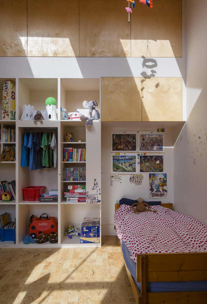 Inspiration for a large contemporary gender neutral children’s room in London with white walls and cork flooring.