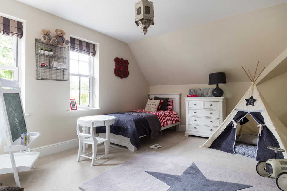 Elegant boy carpeted kids' room photo in London with beige walls