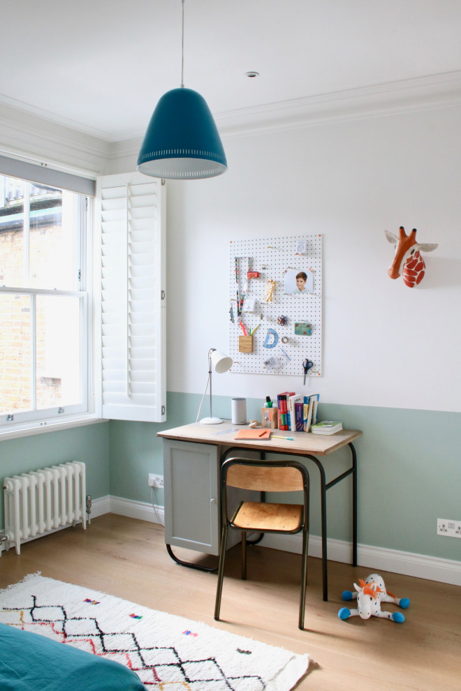 Design ideas for a medium sized contemporary gender neutral kids' bedroom in London with blue walls, light hardwood flooring and beige floors.