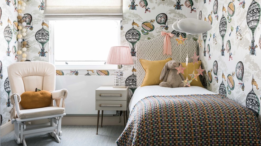 Small classic children’s room for girls in London with multi-coloured walls and carpet.