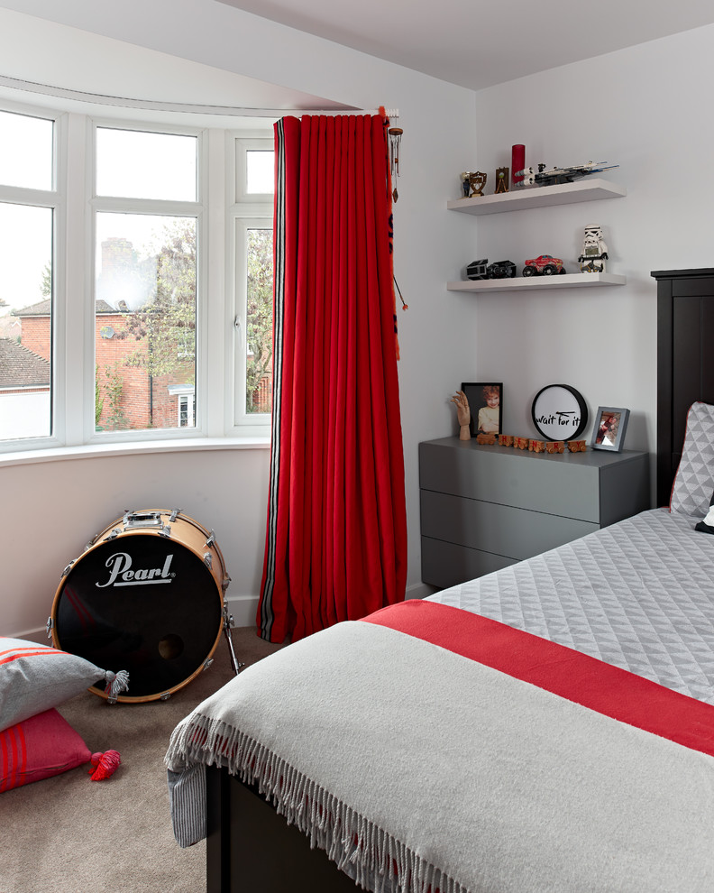 This is an example of a large contemporary teen’s room for boys in Berkshire with white walls, carpet and grey floors.